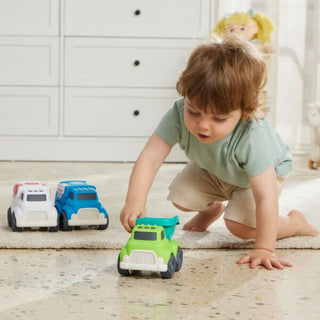 Child playing with toy cars on a carpeted floor