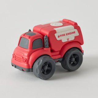 Red toy fire engine on a light gray background