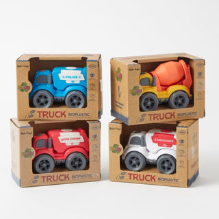 Four toy trucks in bioplastic packaging on a white background