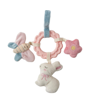 Baby rattle with soft toys on a light gray background