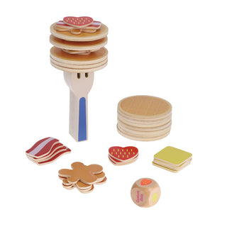 Wooden toy food set with pancakes, bacon, and other items on a white background