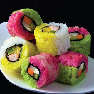 Colorful sushi rolls on a white plate with a black background