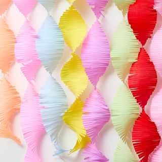 Colorful paper fans arranged in a pattern on a light background