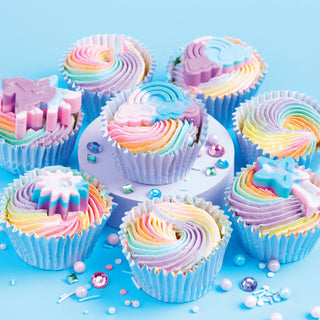 Colorful rainbow cupcakes on a blue background